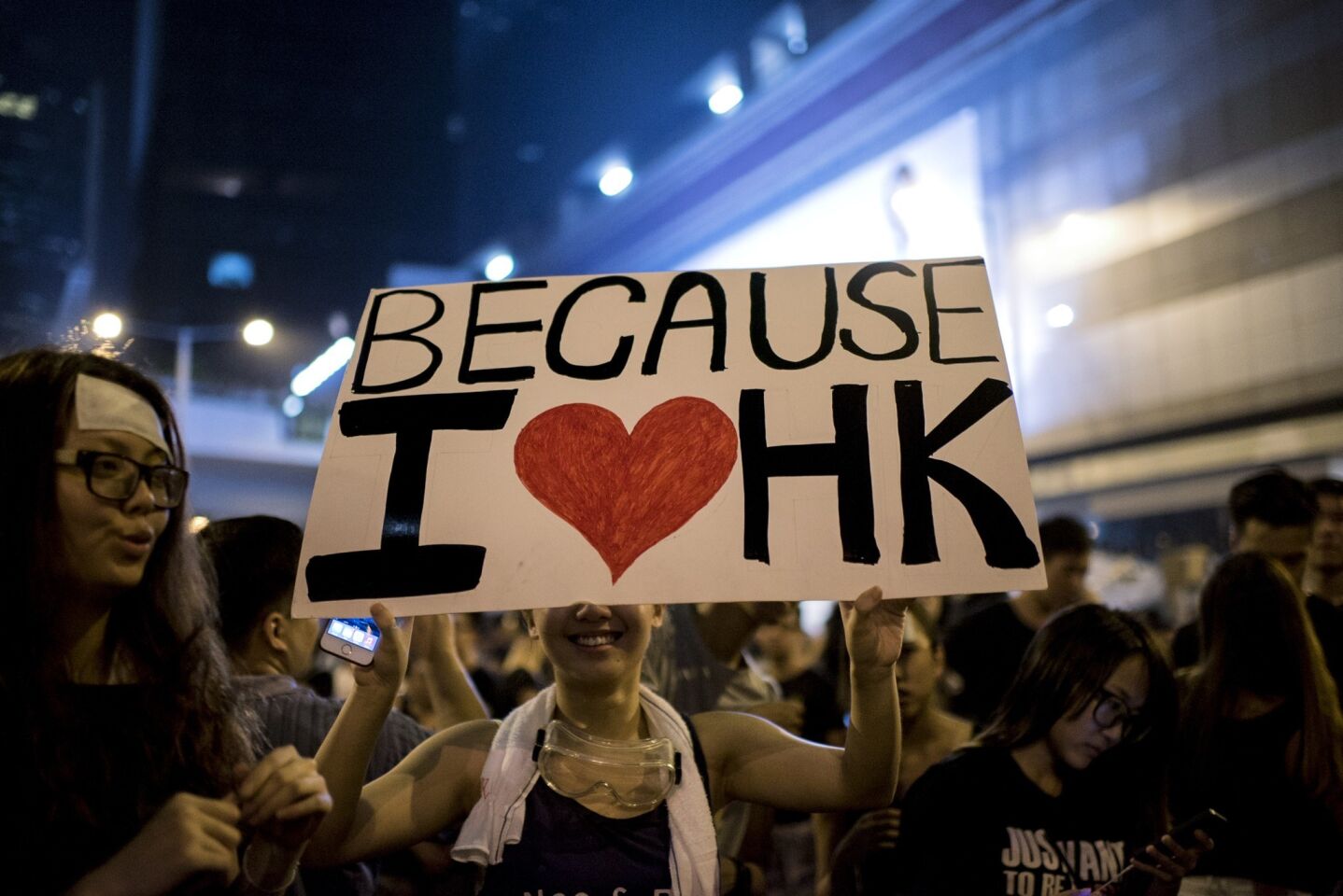 A woman holds a placard at a large pro-democracy protest in Hong Kong.