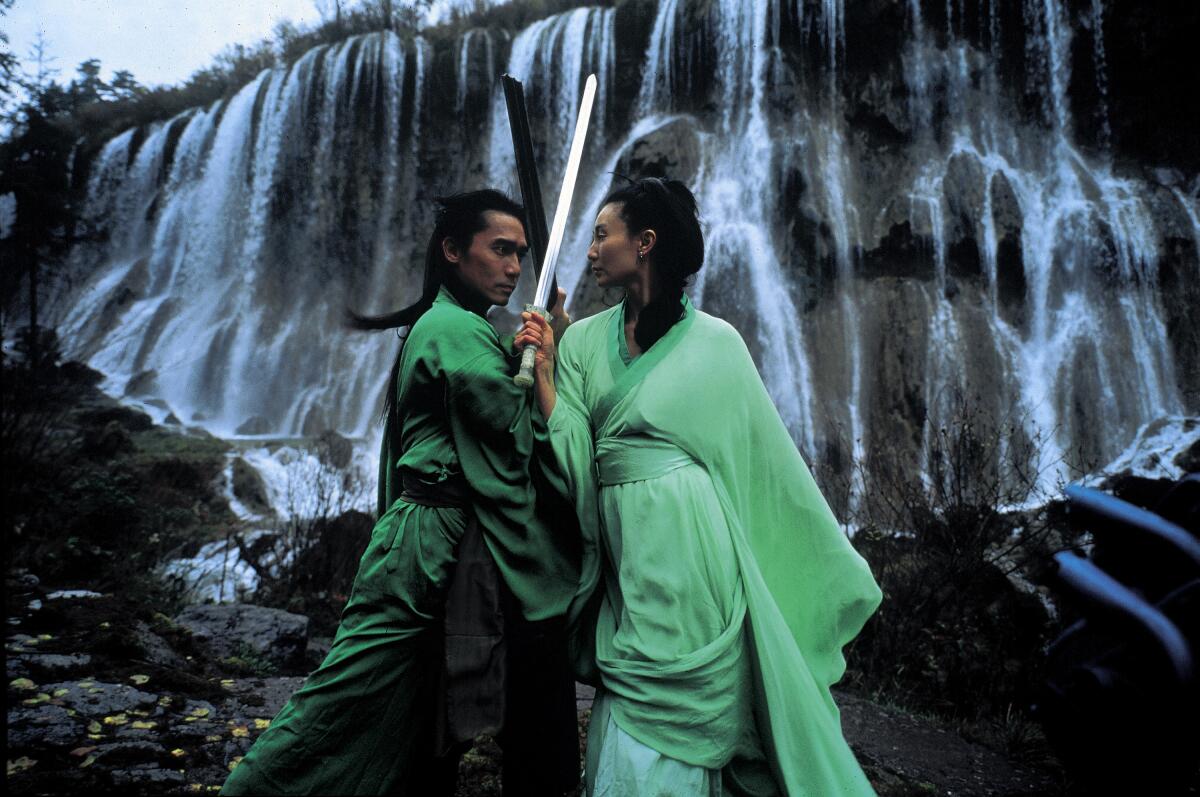 Tony Leung and Maggie Cheung clash in front of a waterfall in "Hero."