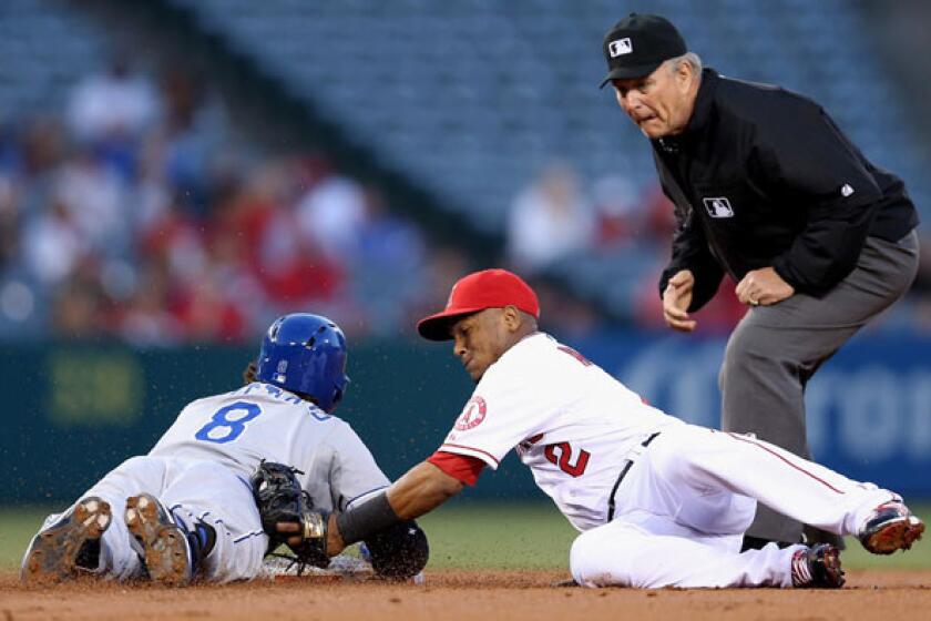 Royals third baseman Mike Moustakas slides safety into second base with a double ahead of the tag by Angels shortstop Erick Aybar in the second inning Wednesday night.