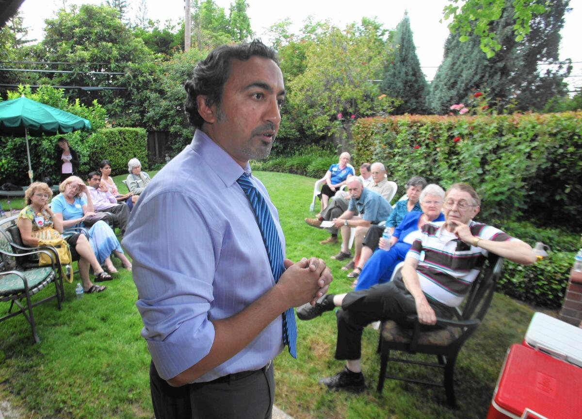 Democrat Ami Bera, talking with supporters in 2010, narrowly won this year's race for his California Congressional seat. Despite millions spent on each candidate's campaign, many people voted along party lines.