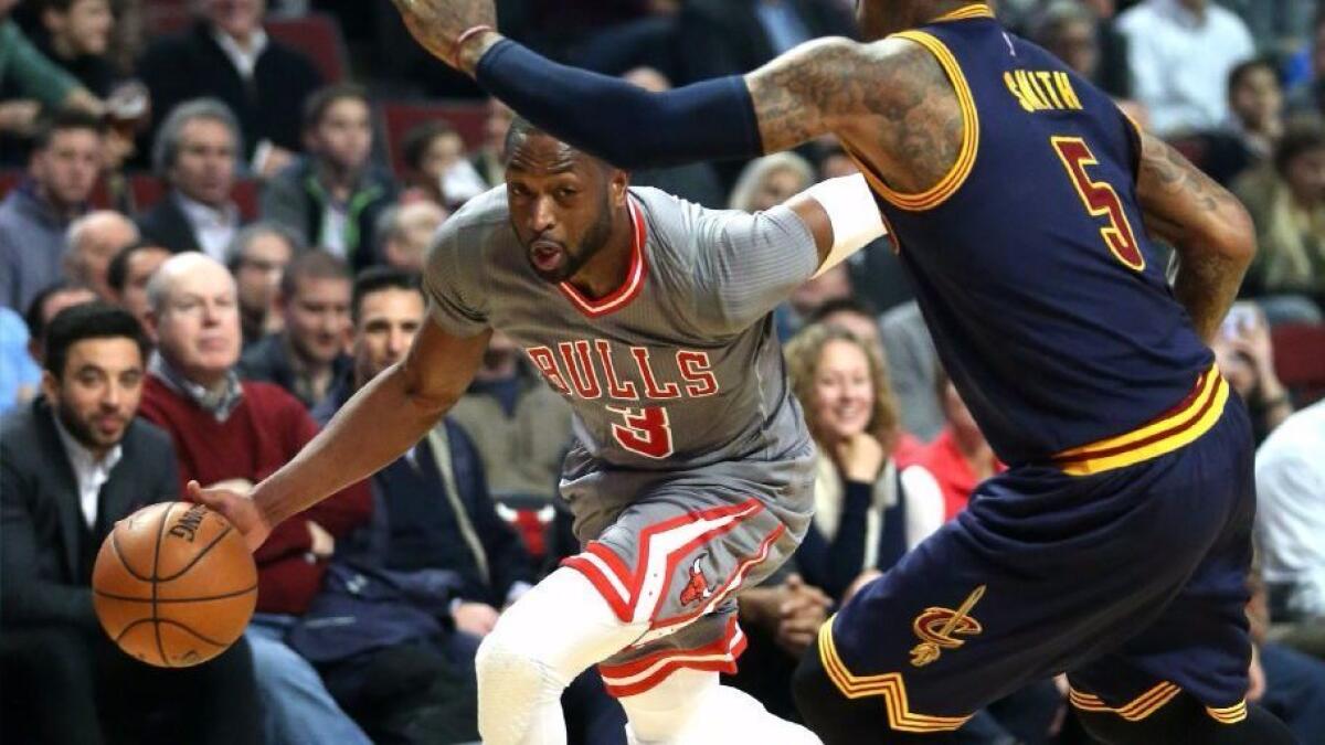 Bulls guard Dwyane Wade drives to the basket against Cavaliers guard J.R. Smith during the first half of a game in Chicago on Dec. 2.