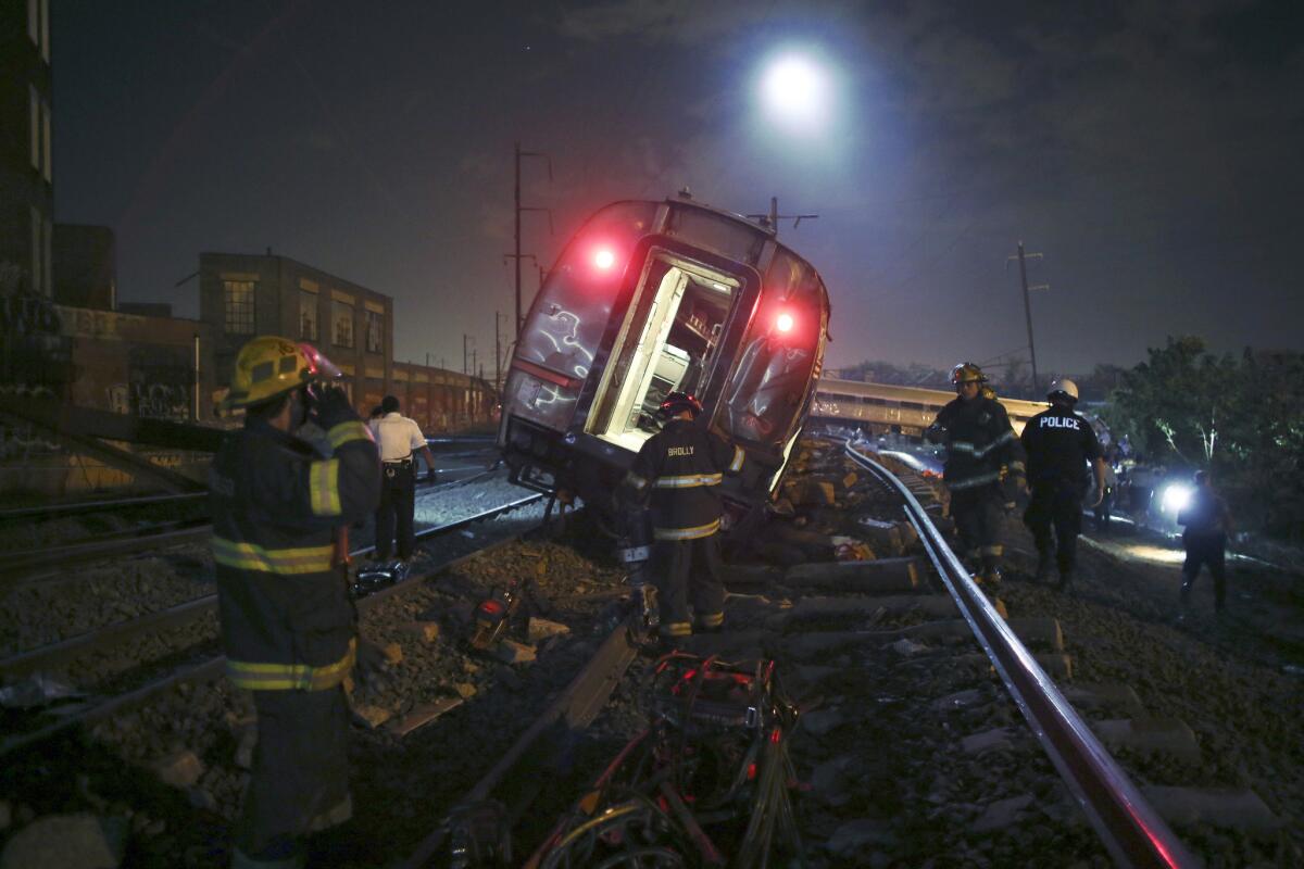 Emergency personnel respond to the Amtrak train derailment late Tuesday in Philadelphia.
