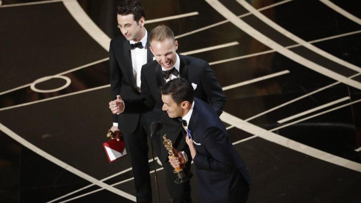 Justin Hurwitz, Justin Paul and Benj Pasek accepting their Oscars for "La La Land's" best original song during the telecast of the 89th Academy Awards in the Dolby Theatre.
