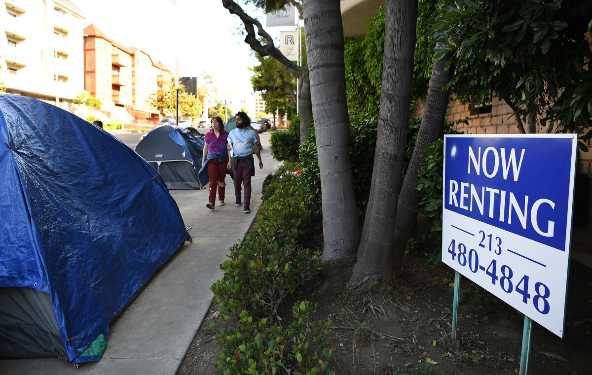 Homeless people set up tents outside the Villa Adobe apartment building in Koreatown.(Wally Skalij / Los Angeles Times)