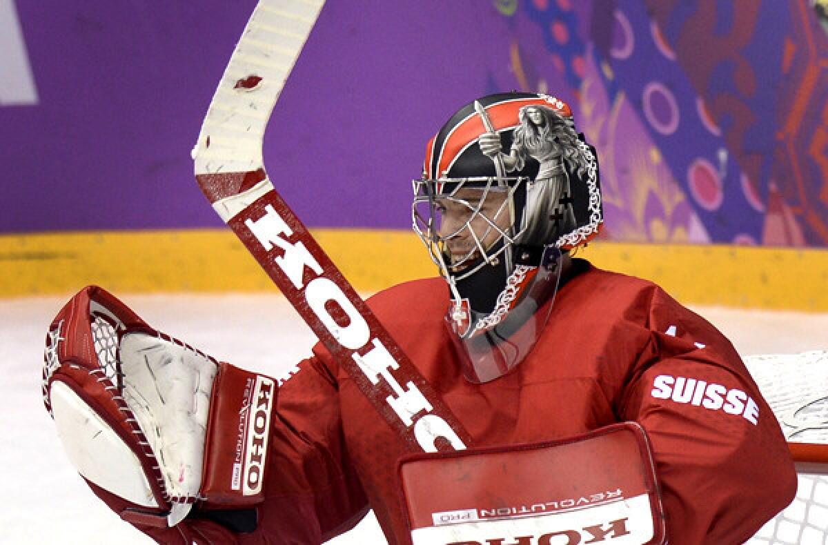 Ducks goalkeeper Jonas Hiller celebrates after helping Switzerland defeat the Czech Republic, 1-0, on Saturday in preliminary-round play.