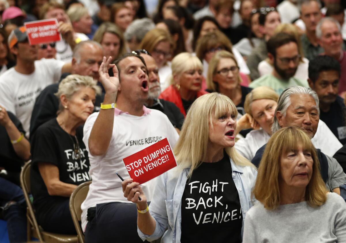 Opponents shout at city officials during a town hall to discuss plans for a homeless shelter in Venice in 2018.