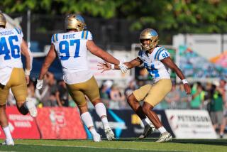 UCLA's Jacob Busic congratulates Mateen Bhaghani after he hit a game-winning field against Hawaii in Aug. 31 in Honolulu