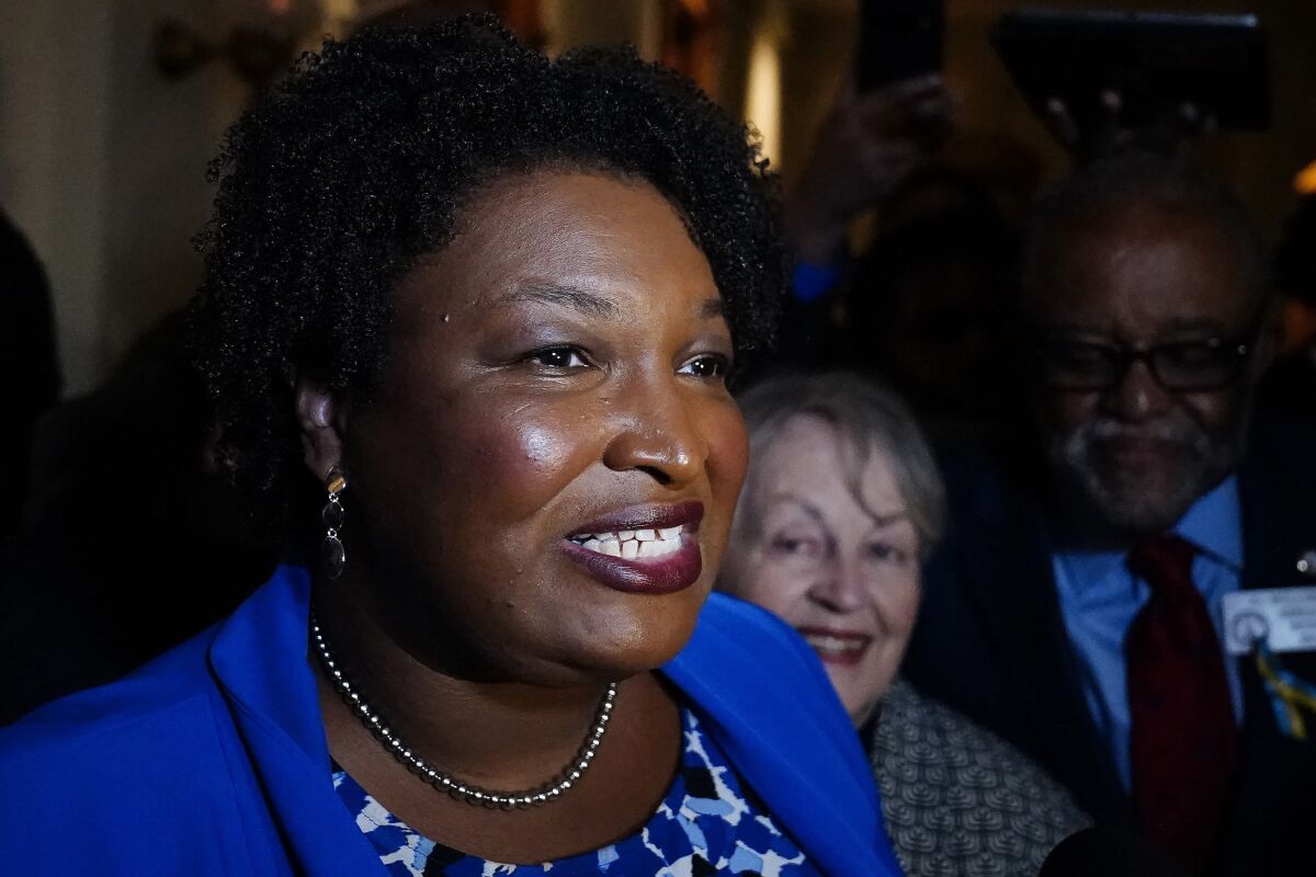 FILE - Georgia gubernatorial Democratic candidate Stacey Abrams talks to the media after qualifying for the 2022 election on Tuesday, March 8, 2022, in Atlanta. Abrams has become a millionaire. A disclosure filed in March shows the candidate for governor is worth $3.17 million, thanks mostly to book and speaking income. Abrams was worth $109,000 in 2018 when she first ran for governor. (AP Photo/Brynn Anderson, File)