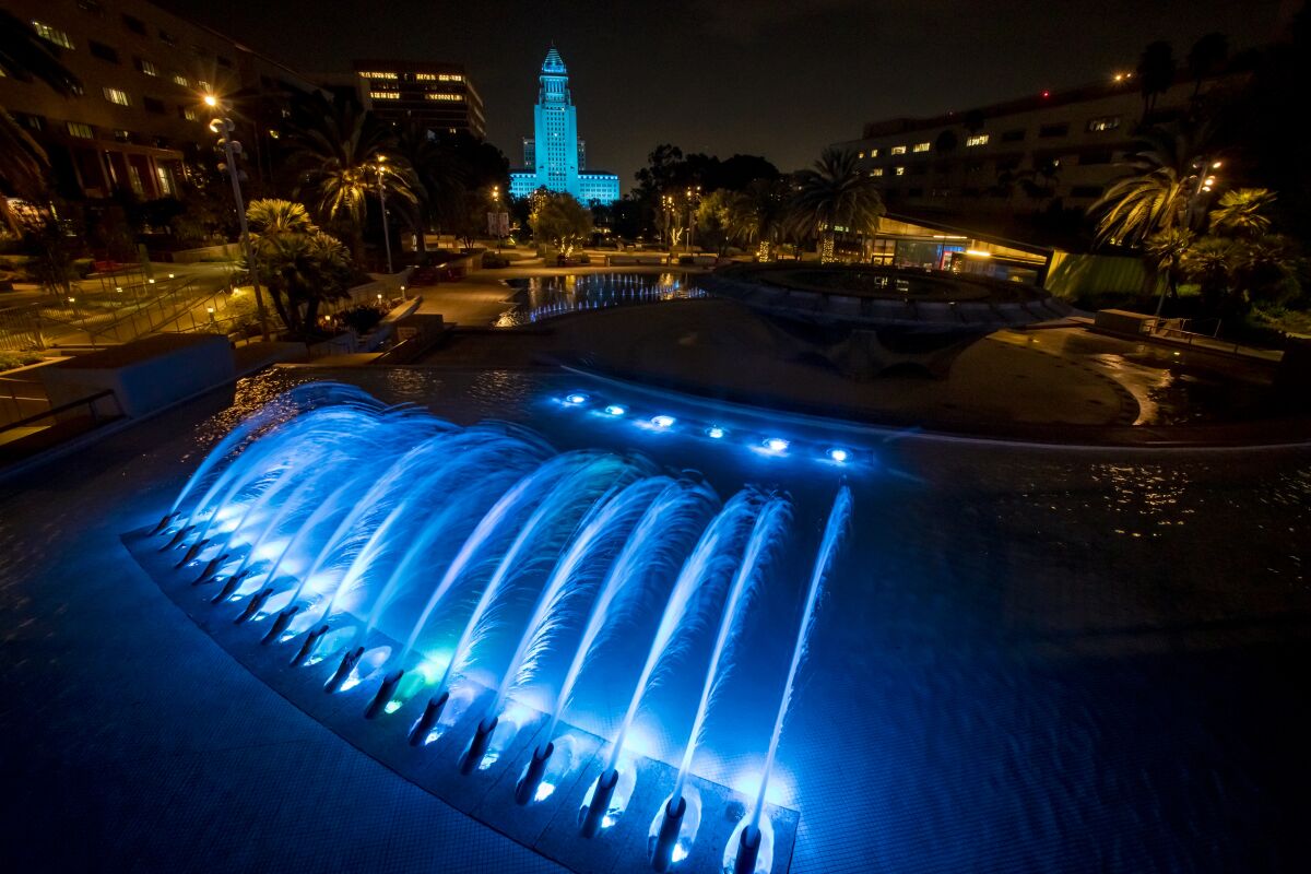 The LA City Hall in the background and the fountain at Grand Park in the foreground, both dipped in dodger blue.