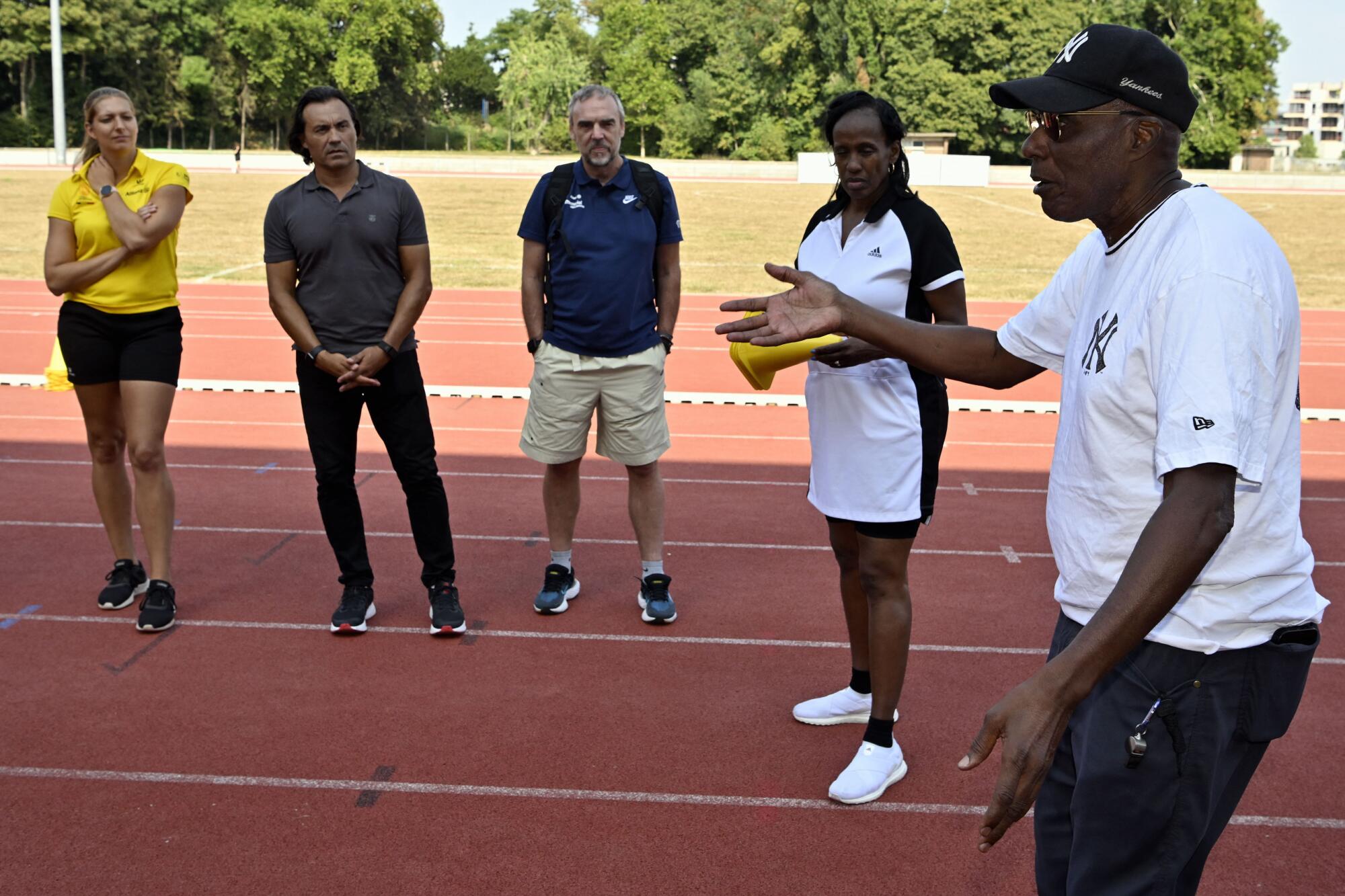 Track and field trainer Bob Kersee and wife Jackie Joyner-Kersee hold a long jump clinic in Vilvoorde, Belgium.
