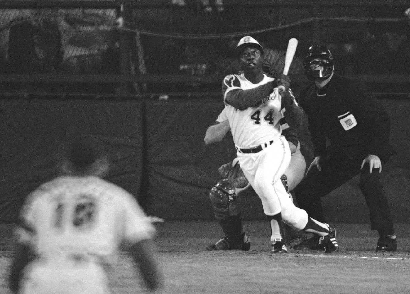** FILE ** Atlanta Braves' Hank Aaron eyes the flight of the ball after hitting his 715th career homer in a game against the Los Angeles Dodgers in Atlanta, Ga., in this April 8, 1974 file photo. Dodgers pitcher Al Downing, catcher Joe Ferguson and umpire David Davidson look on. (AP Photo/Harry Harrris)