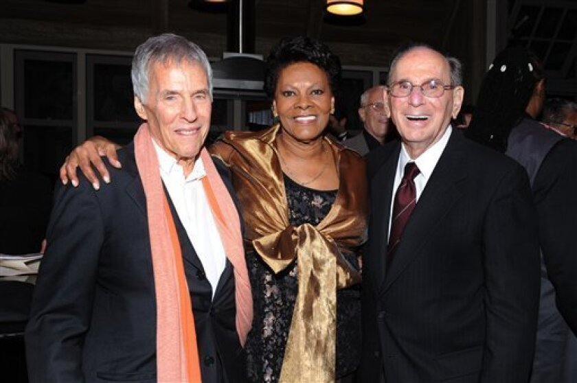 FILE - This Oct. 17, 2011 file photo shows legendary songwriters Burt Bacharach, left, and Hal David pose with singer Dionne Warwick at the "Love, Sweet Love" musical tribute to Hal David on his 90th birthday in Los Angeles. David, who along with Bacharach penned dozens of top 40 hits for a variety of recording artists in the 1960s and beyond, died Sept. 1, 2012. (AP Photo/Vince Bucci, File)