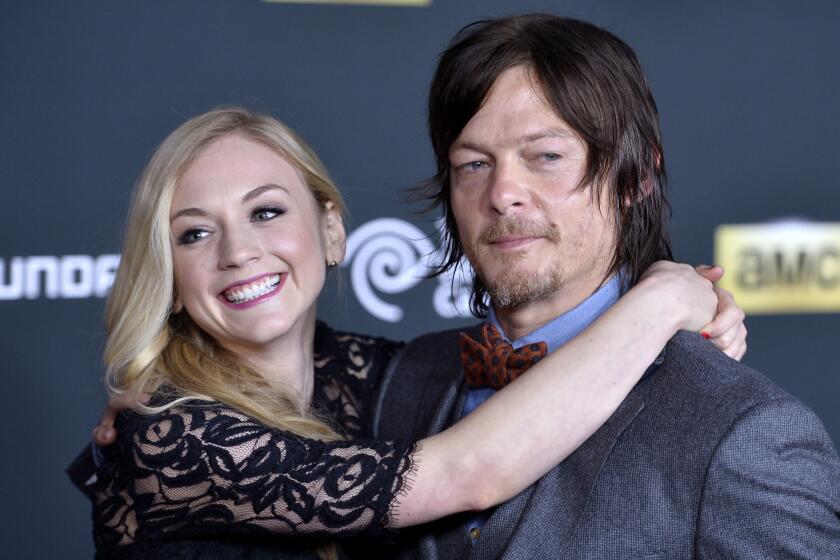 "The Walking Dead's" Emily Kinney and Norman Reedus, shown in 2013, are not dating, his rep said.