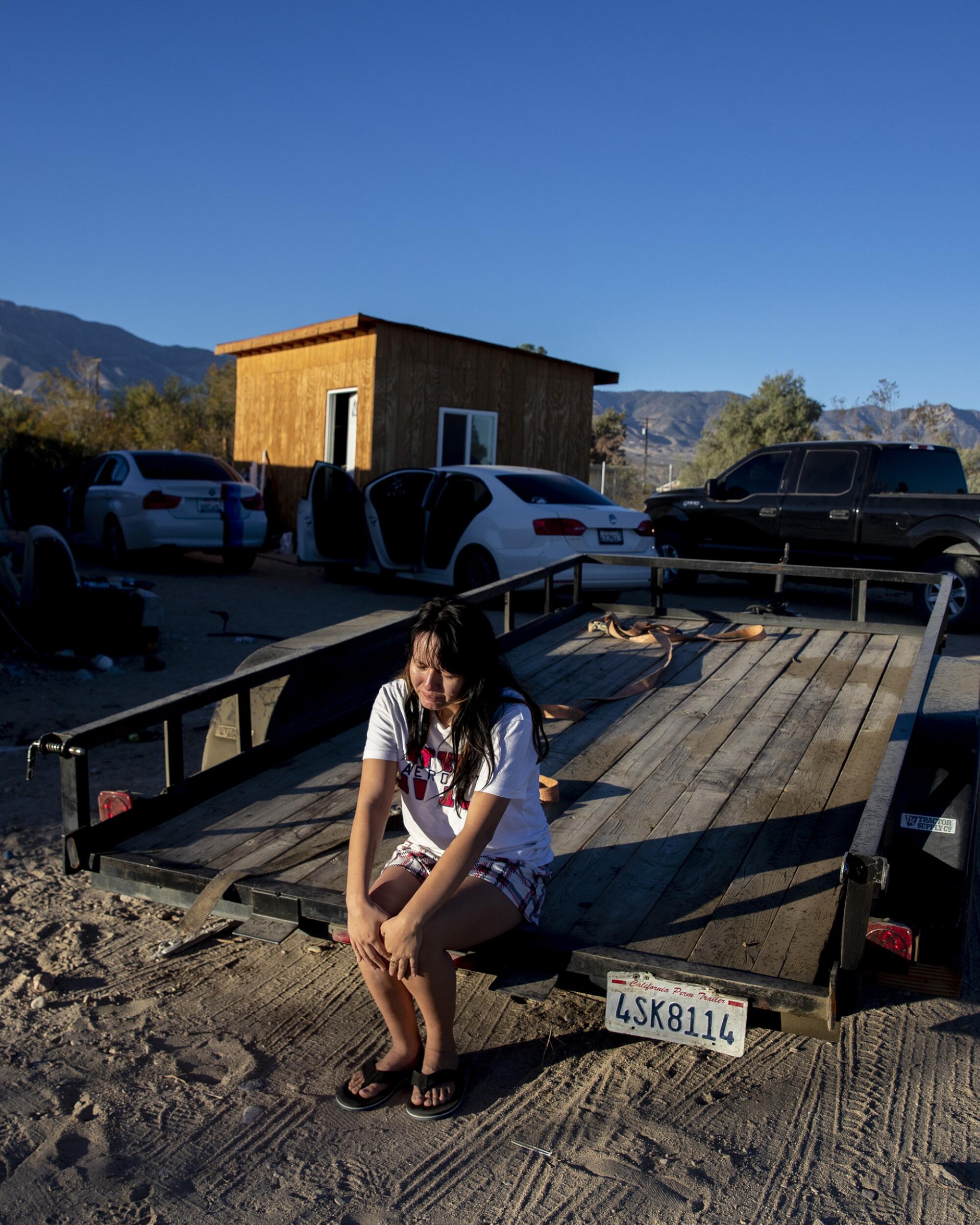 A woman weeps during a police raid of an illicit farm.