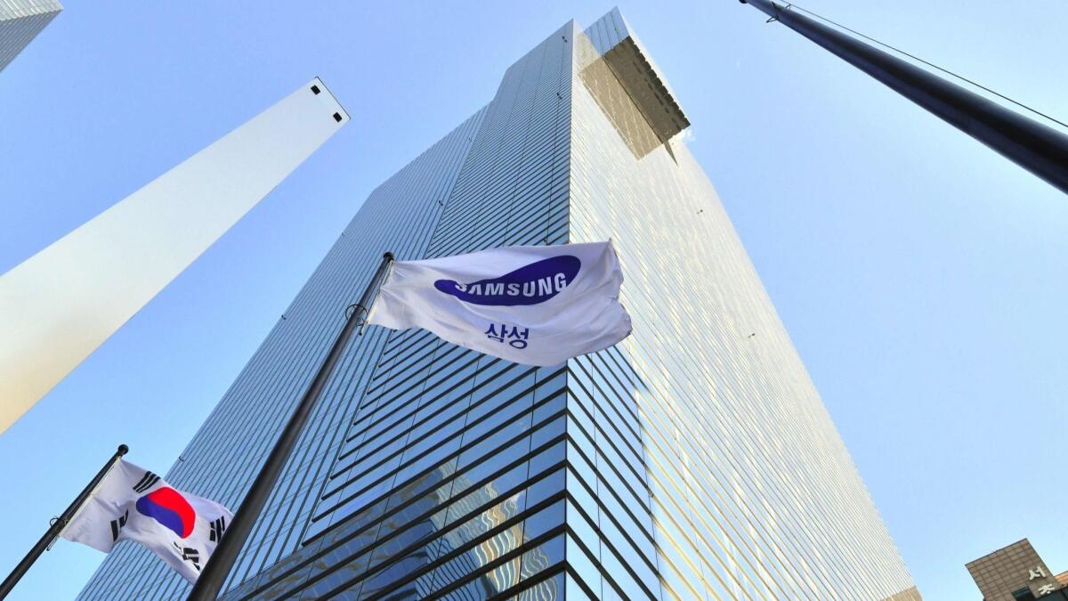 A Samsung flag and South Korean flag outside the Samsung building in Seoul in January. Analysts say part of problem for young job seekers in South Korea is the widening gap between the quality of jobs at family-owned conglomerates like Samsung and the rest of the players.