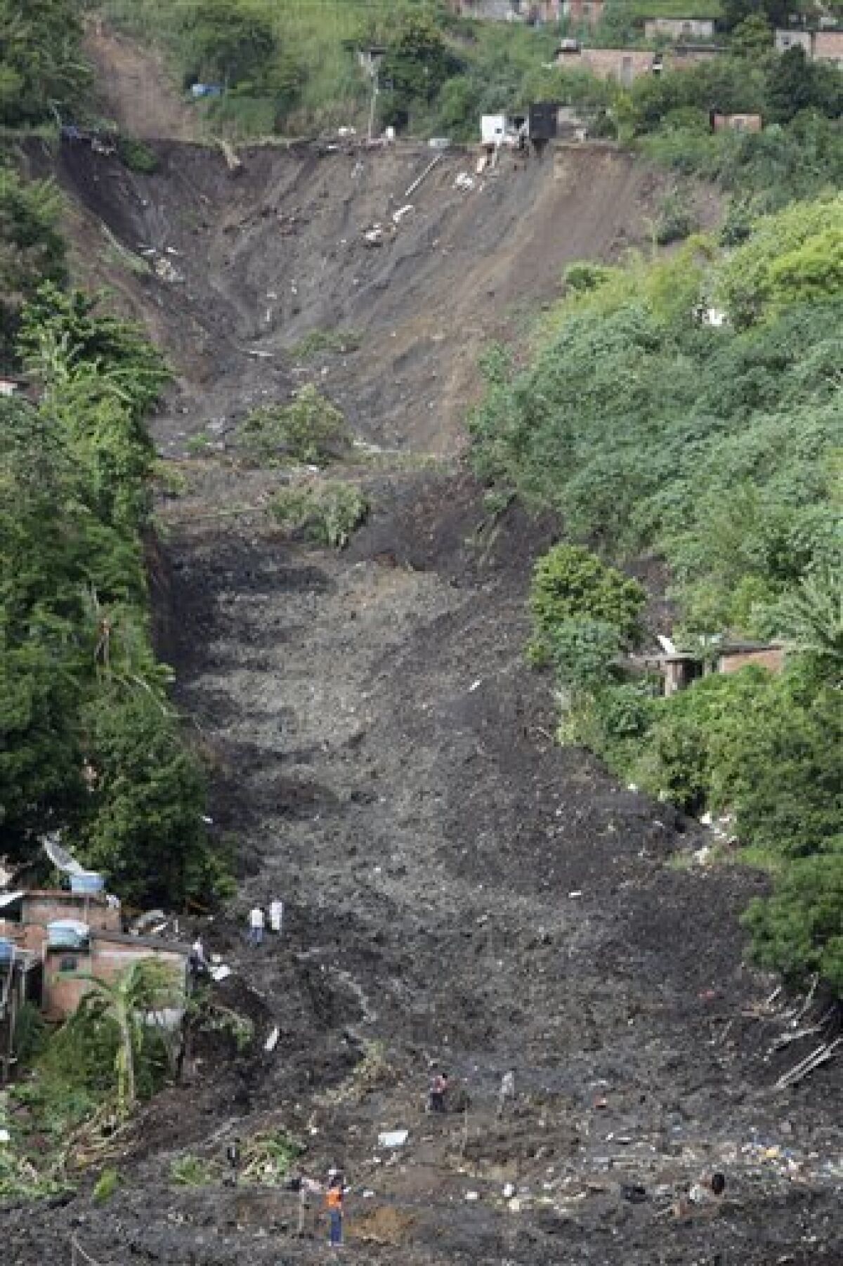 The Morro do Bumba area where a landslide buried homes is seen in the Niteroi neighborhood of Rio de Janeiro, Thursday, April 8, 2010. At least 200 people were buried and feared dead under the latest landslide to hit a slum in Rio de Janeiro's metropolitan area, authorities said Thursday. (AP Photo/Felipe Dana)