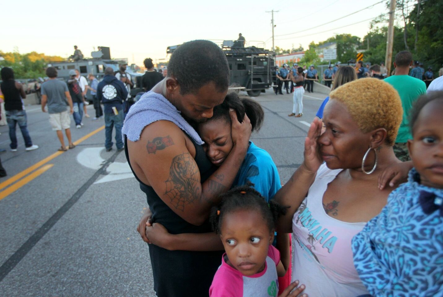The Williams family is overcome with emotion after Terrell Williams El, left, confronted police. "I'm out here to stand for my children and their future," said Williams El.