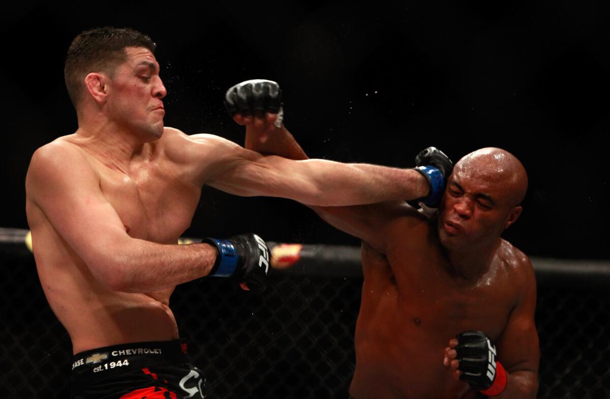 Nick Diaz, left, and Anderson Silva trade punches in their middleweight bout at the MGM Grand Garden Arena in Las Vegas.