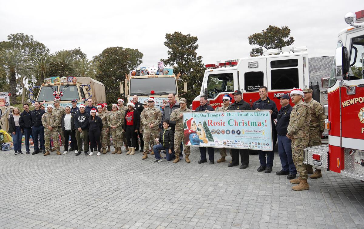 Members of the fire department and military service members stand for group picture.