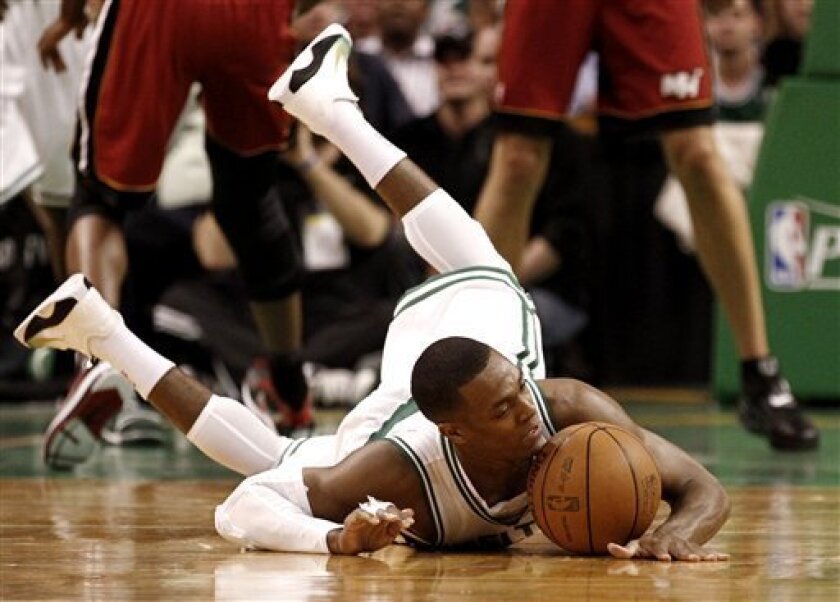 Boston Celtics' Rajon Rondo hits the floor after being tripped during the first quarter of Game 3 of a second-round NBA playoff basketball series against the Miami Heat in Boston Saturday, May 7, 2011. (AP Photo/Winslow Townson)