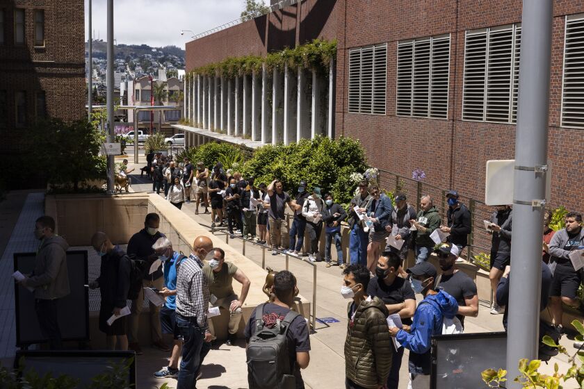 FILE - People stand in long lines to receive the monkeypox vaccine at San Francisco General Hospital in San Francisco, Tuesday, July 12, 2022. (Jessica Christian/San Francisco Chronicle via AP, File)
