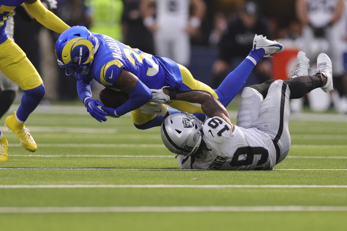 Rams safety Jaylen McCollough intercepts a pass intended for Raiders wide receiver DJ Turner.