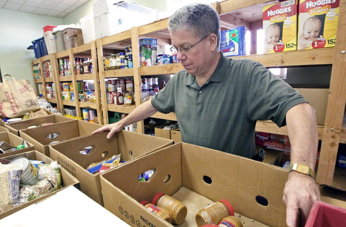 Rick White with the Salvation Army looks over the group's food stocks for their food assistance program on Wednesday, Feb. 12, 2014.