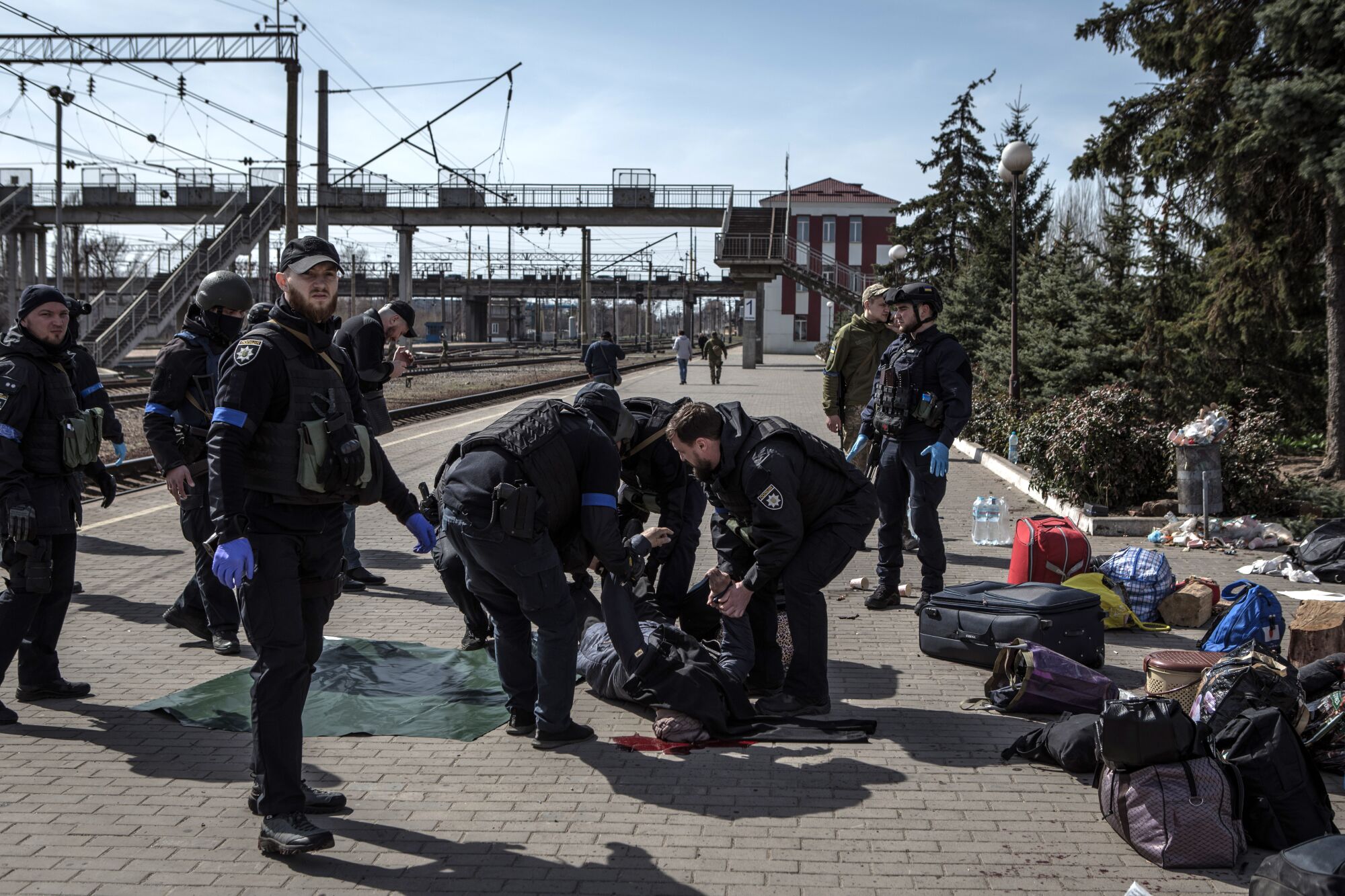 Security personnel move a body after Friday's rocket attack at the Kramatorsk train station.