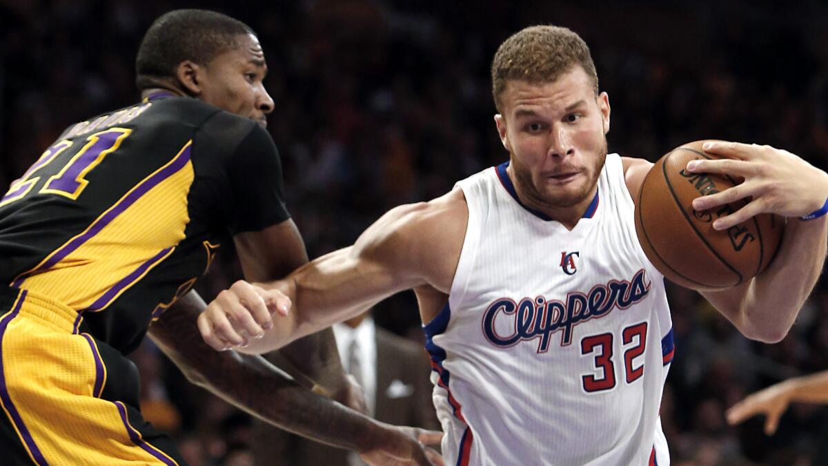 Clippers forward Blake Griffin, right, drives past Lakers forward Ed Davis during the Clippers' win on Oct. 31 at Staples Center.
