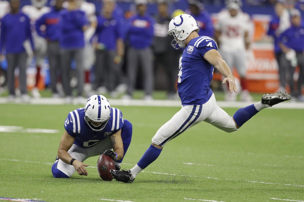 Indianapolis Colts' Adam Vinatieri (4) kicks a field goal from the hold of Rigoberto Sanchez during an NFL football game.