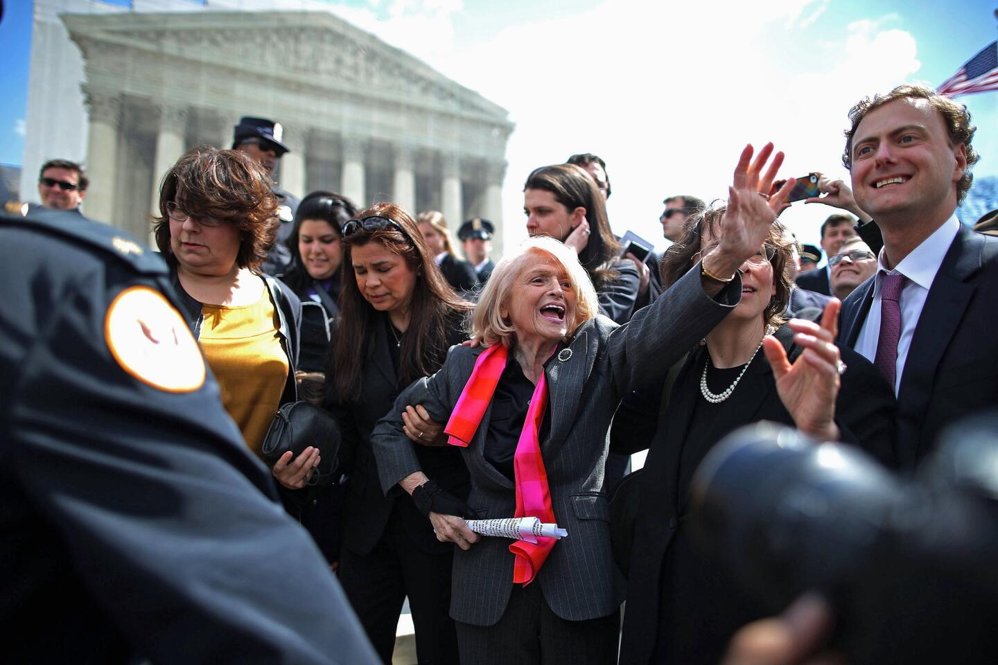 Edith Windsor, 83, is mobbed by journalists and supporters as she leaves the Supreme Court on Wednesday. Windsor brought the case challenging the constitutionality of the federal Defense of Marriage Act.