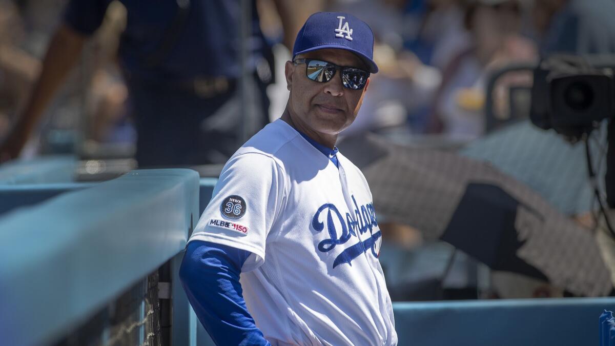Dodgers manager Dave Roberts keeps an eye on the dugout during a game against the Rockies at Dodger Stadium on June 23. The Dodgers are sitting on 60 wins with one game to go before the All-Star break.