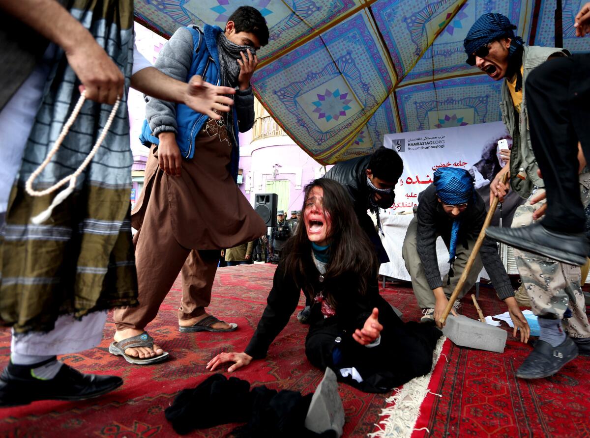 Afghan artists reenact the mob killing of Farkhunda Malikzada, 27, an Afghan woman who was beaten to death on March 19, 2015, after being falsely accused of burning a copy of the Koran in Kabul.