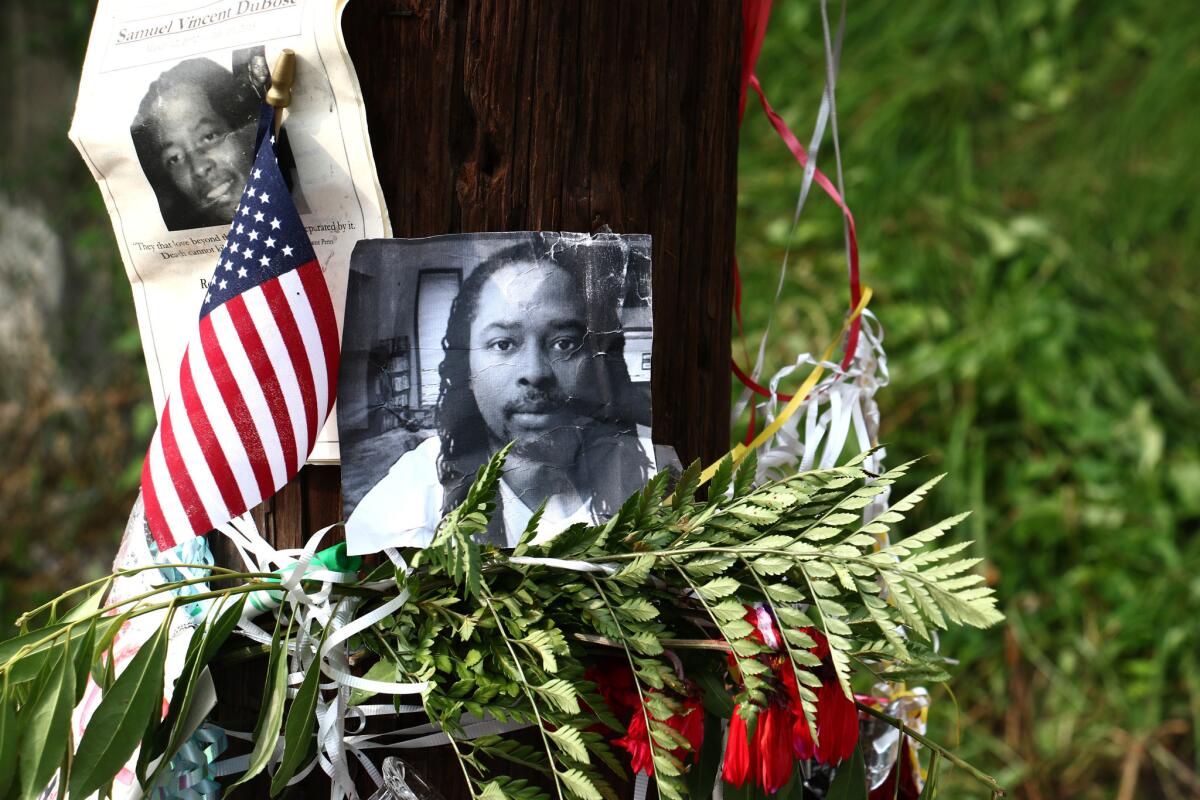 In this July 29, 2015, file photo, photos of Samuel DuBose hang on a pole at a memorial near where he was shot and killed by a University of Cincinnati police officer. (Tom Uhlman / AP)