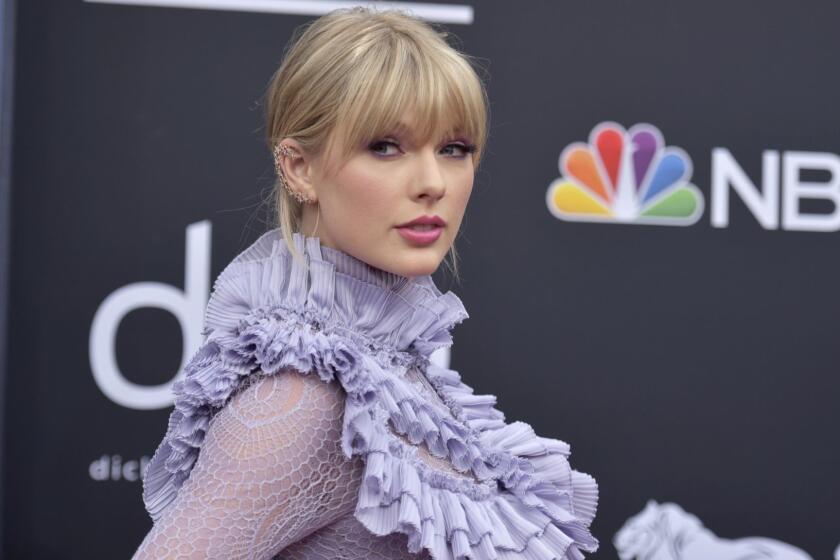 FILE - In this May 1, 2019 file photo, Taylor Swift arrives at the Billboard Music Awards at the MGM Grand Garden Arena in Las Vegas. Scooter Brauns Ithaca Holdings acquired Big Machine Label Group, home to Swifts first six albums, including the Grammy winners for album of the year, 2008s Fearless and 2014s 1989. (Photo by Richard Shotwell/Invision/AP, File)