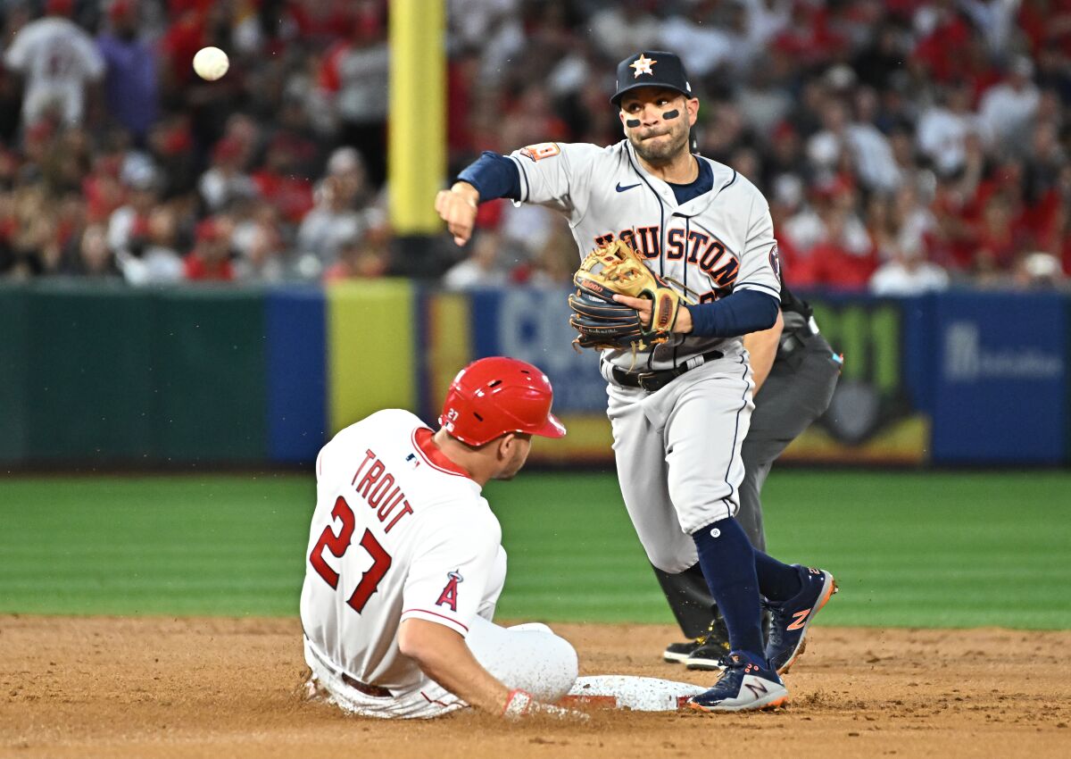 Angels' Mike Trout is forced out at second base by Houston Astros second baseman Jose Altuve.