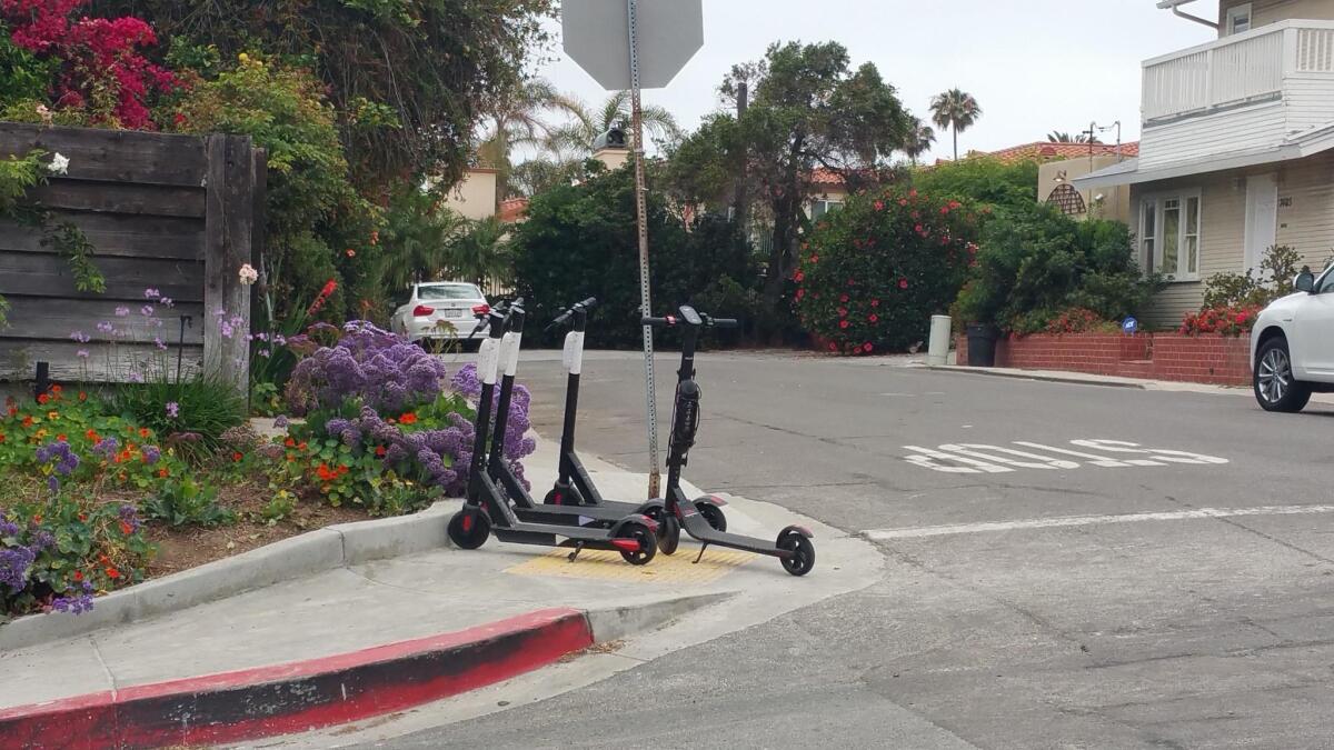 These scooters seen in La Jolla are completely blocking public sidewalks and curb access.