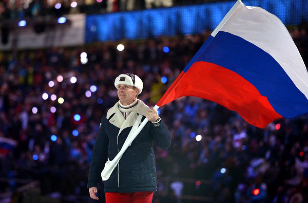 Bobsled pilot Alexander Zubkov carries Russia's flag into Fisht Olympic Stadium during the opening ceremony of the Sochi Olympics.