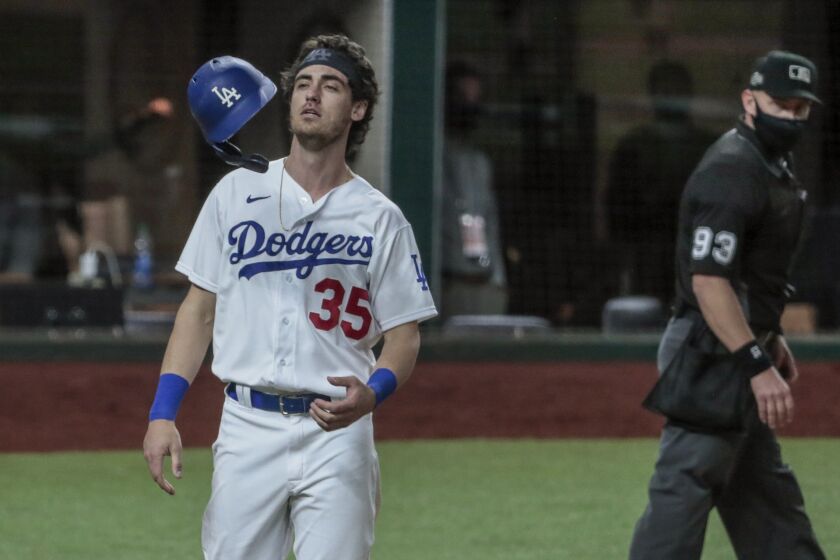 A weary and frustrated Cody Bellinger tosses his helmet.