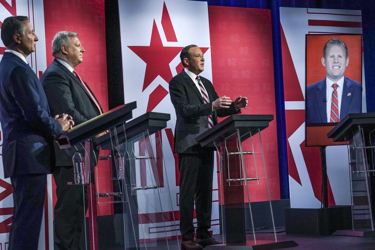 Former Westchester County Executive Rob Astorino, far left, businessman Harry Wilson, second from left, Suffolk County Congressman Lee Zeldin, second from right, and Andrew Giuliani, far right, son of former New York City Mayor Rudy Giuliani, face off during New York's Republican gubernatorial debate at the studios of CBS2 TV, Monday, June 13, 2022, in New York. Giuliani participated via virtual broadcast after he was blocked from the studios for not meeting vaccine requirements. (AP Photo/Bebeto Matthews)