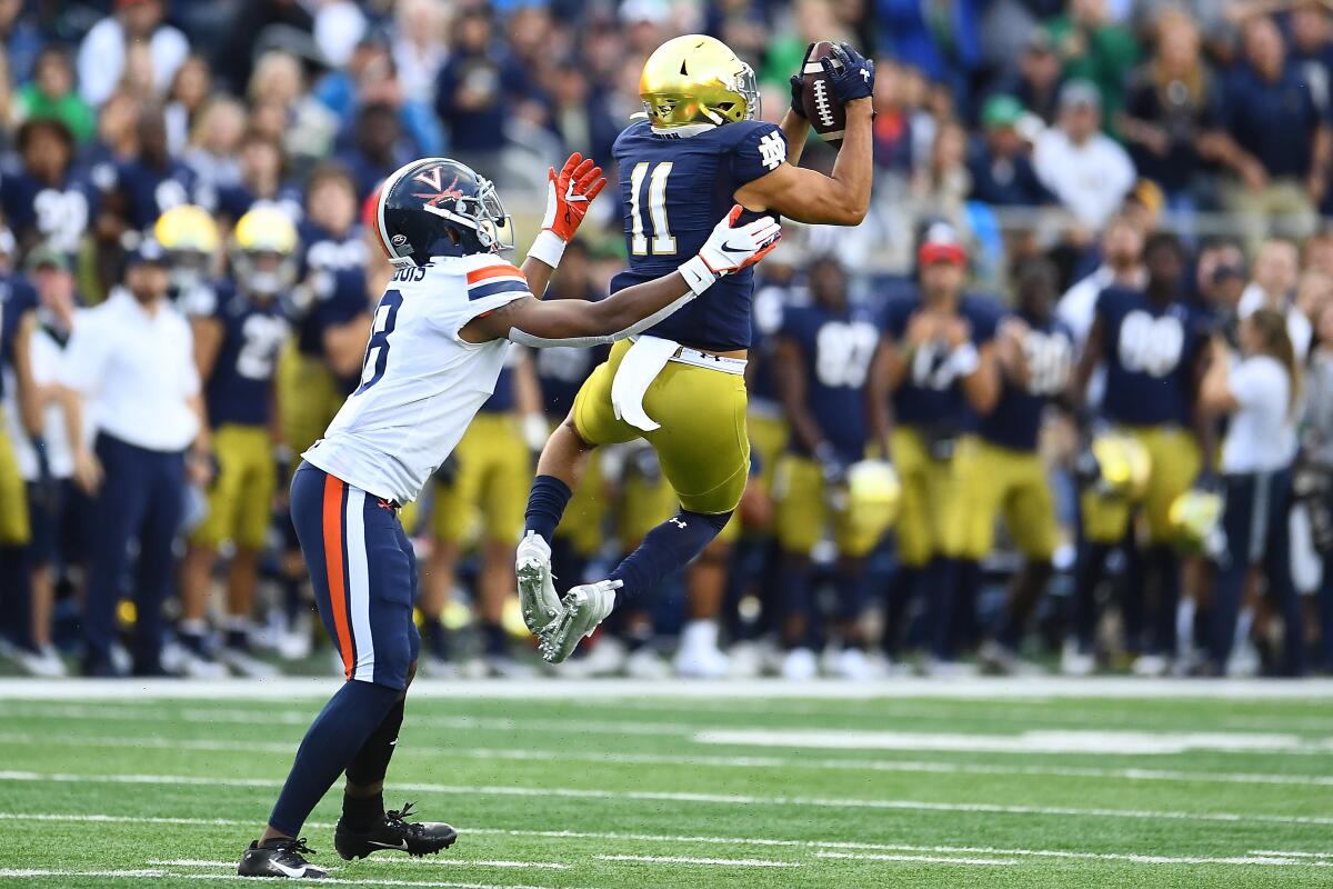 Notre Dame safety Alohi Gilman intercepts a pass against Virginia.