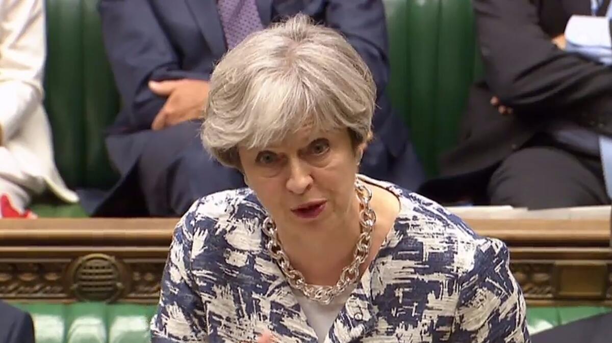Prime Minister Theresa May speaks in the House of Commons in London on Monday about her proposals for citizens of other European Union countries who live in Britain.