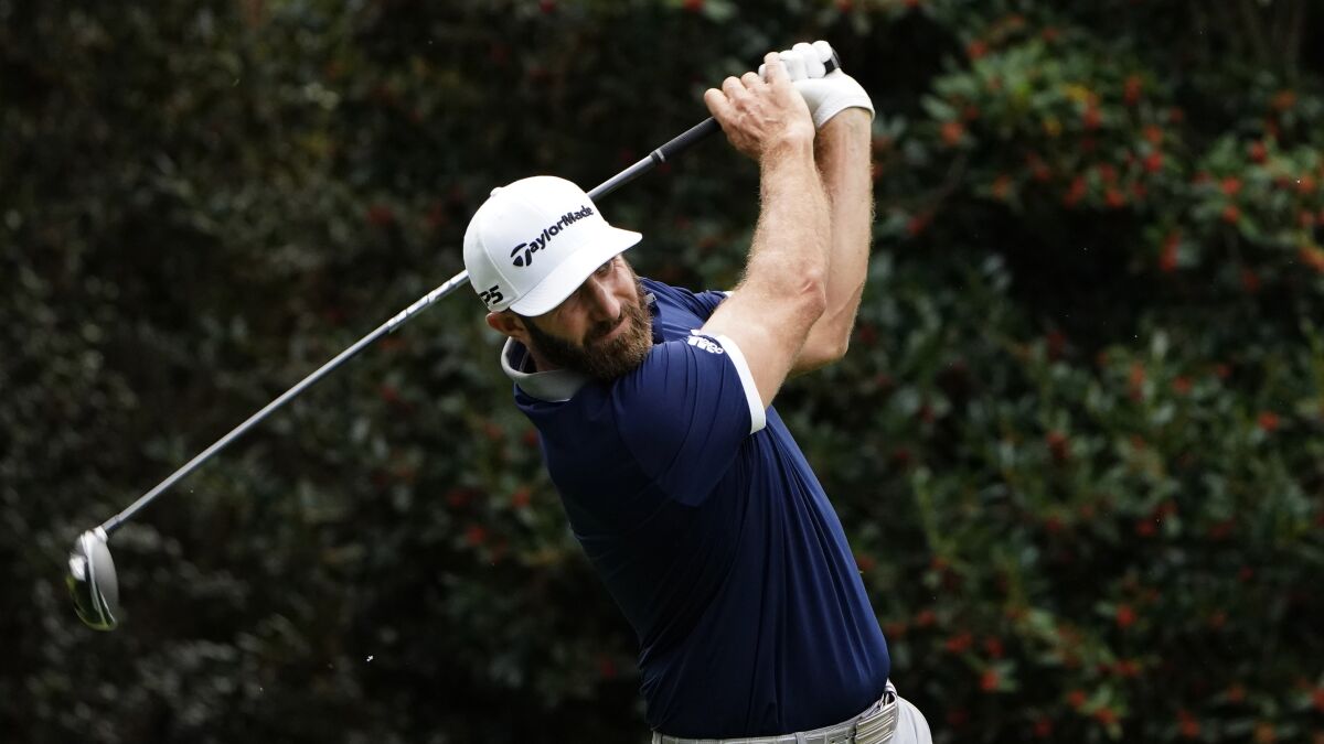Dustin Johnson hits a shot Nov. 13, 2020, at the Masters. He was a co-leader after the day's play finished.