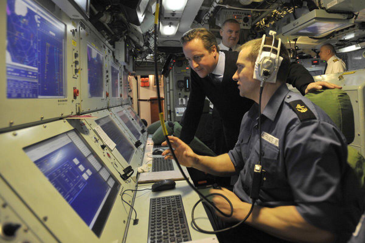 British Prime Minister David Cameron, left, visits the Trident nuclear submarine Victorious on patrol off the west coast of Scotland.