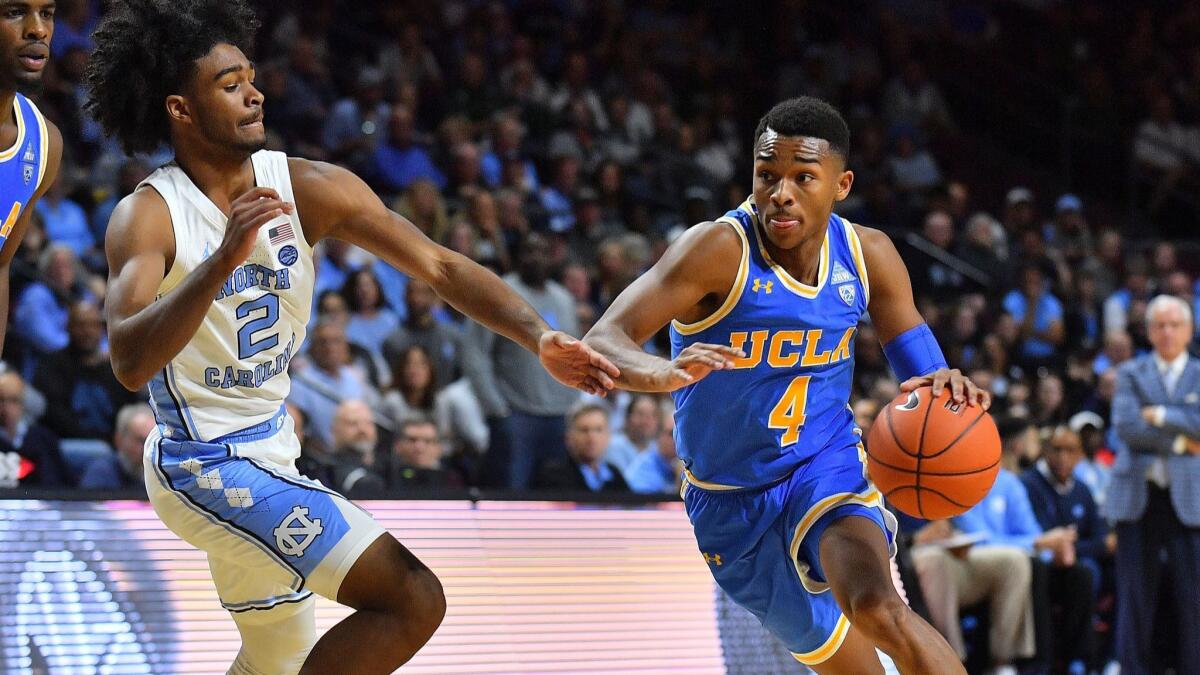 UCLA's Jaylen Hands (4) drives against North Carolina's Coby White (2) at the Orleans Arena in Las Vegas on Nov. 23, 2018. North Carolina defeated UCLA 94-78.