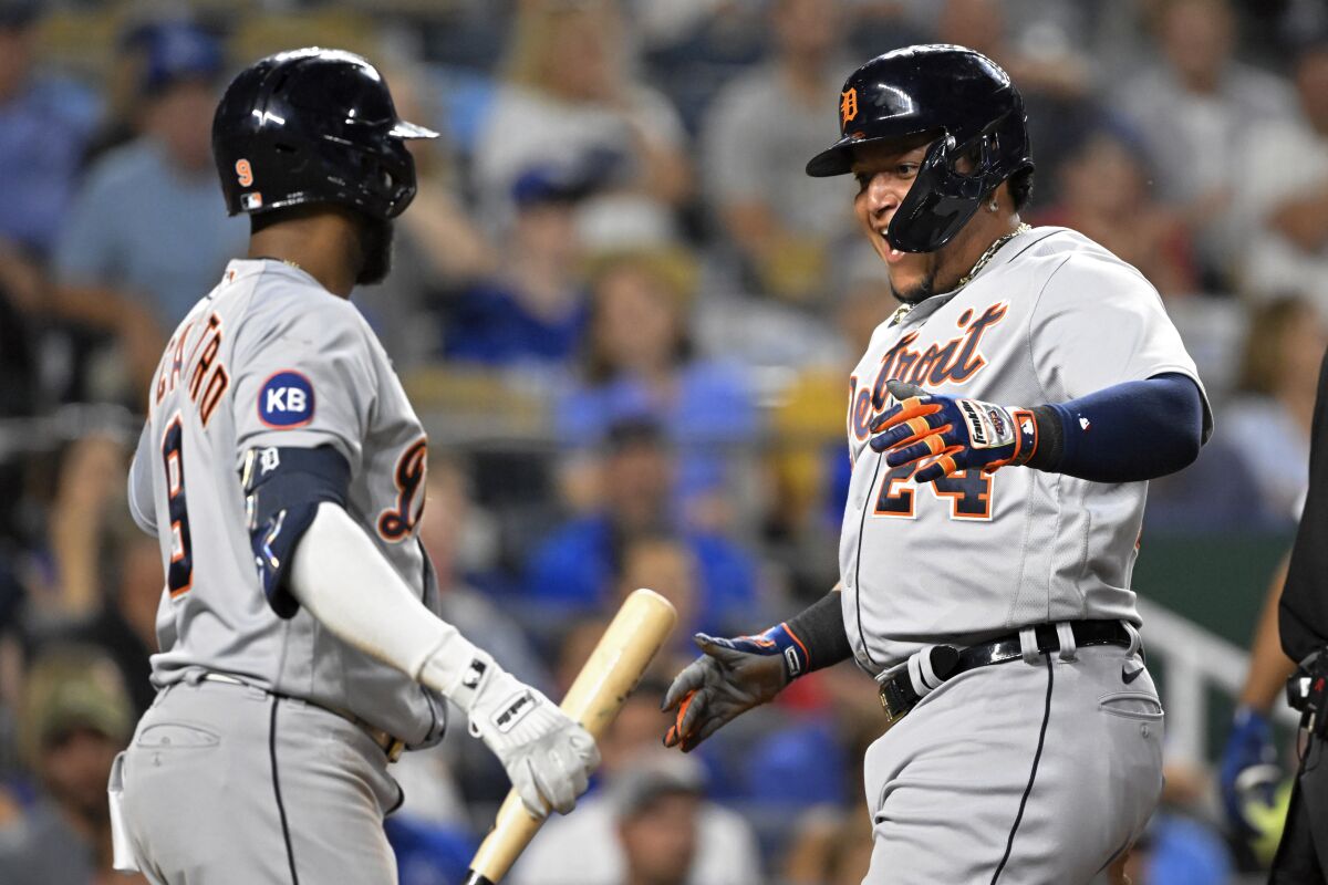Detroit Tigers' Miguel Cabrera (24) celebrates scoring against the Kansas City Royals with teammate Willi Castro (9) during the seventh inning of a baseball game, Tuesday, July 12, 2022, in Kansas City, Mo. (AP Photo/Reed Hoffmann)