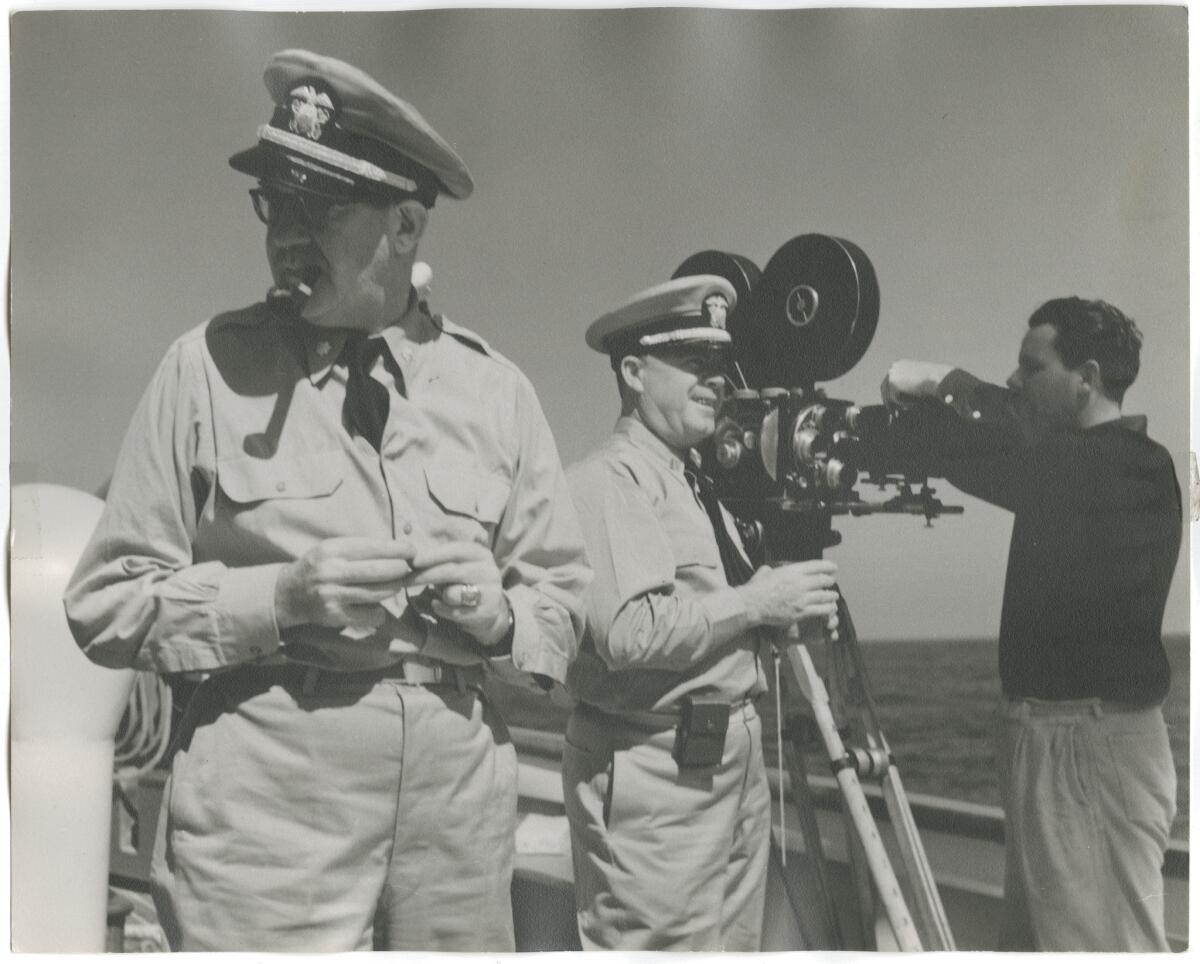 John Ford, left, next to his cameraman in the Pacific. The image is from "Filming the Camps: John Ford, Samuel Fuller, George Stevens, From Hollywood to Nuremberg," at the Los Angeles Museum of the Holocaust.