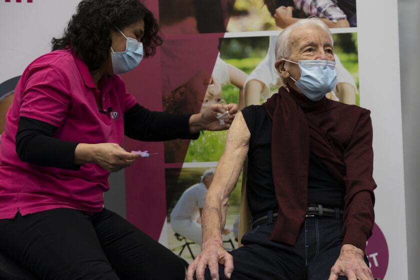 Jos Bieleveldt, 91, receives a COVID-19 vaccine in Apeldoorn, Netherlands, Tuesday, Jan. 26, 2021. Jos Bieleveldt had a spring in his 91-year-old step when he became one of the first Dutch recipients in his age group to get the coronavirus vaccine. One thing though, it really took too long a time coming. The 27-nation EU is coming under criticism for the slow rollout of its vaccination campaign. The bloc, a collection of many of the richest countries in the world, is not faring well in comparison to countries like Israel, the United Kingdom and the United States. (AP Photo/Peter Dejong)