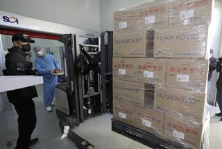 FILE - A worker moves boxes carrying Novavax's COVID-19 vaccine at SK Bioscience Co. in Andong, South Korea, on Feb. 9, 2022. Before the pandemic, Novavax was a small American company that had never brought any vaccine to market. Its shots have proven highly effective, but it is relying heavily on other companies to make them. (Kim Hyun-tae/Yonhap via AP, File)