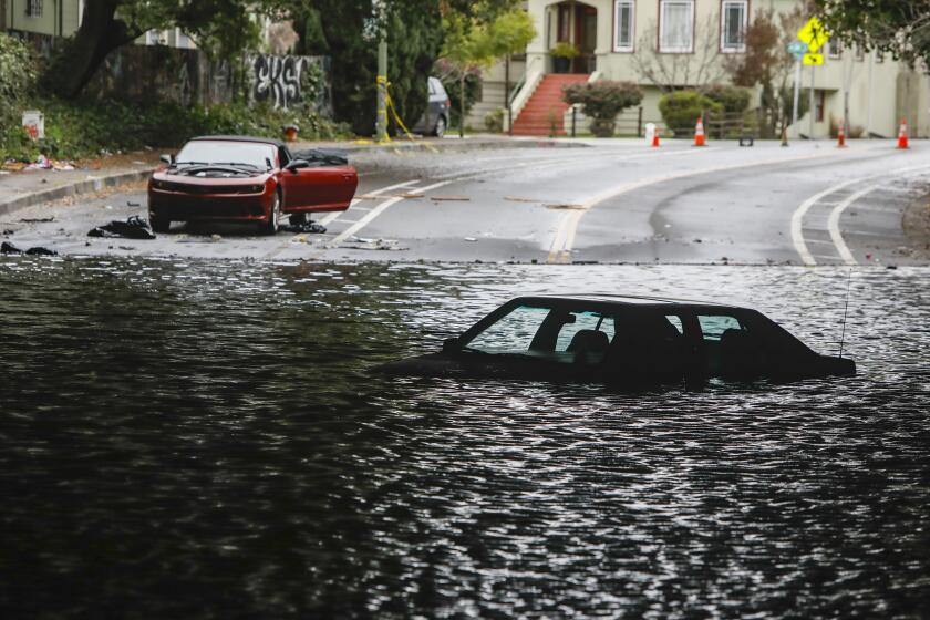 Cars sit stuck in a flooded underpass at Webster St. and 34th St. that has been flooded since this weekend's storm in Oakland, Calif., on Wednesday, January 4, 2023. (Salgu Wissmath/San Francisco Chronicle via AP)